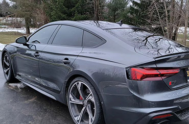 A grey car with tinted windows