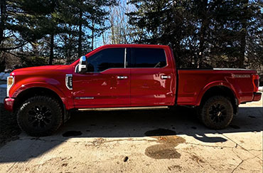 A red truck with tinted windows